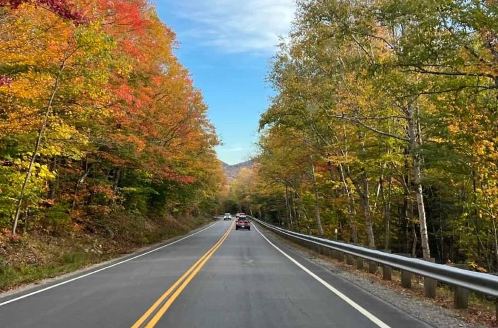 Vibrant red and orange trees line the Kancamagus Highway in New Hampshire during October