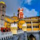Family laughing at Pena Palace colorful towers in Sintra Portugal