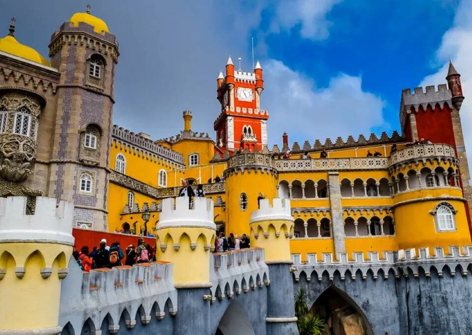 Family laughing at Pena Palace colorful towers in Sintra Portugal