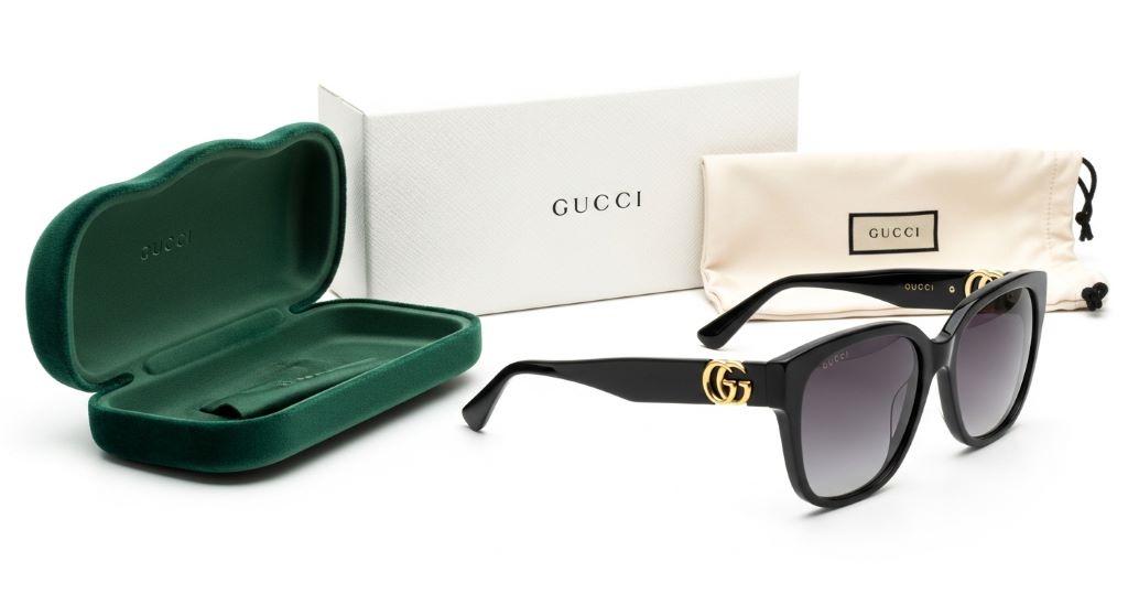 Gucci sunglasses displayed on a clean white background with original case and packaging