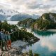 Travelers kayaking near untouched islands in Chilean Patagonia surrounded by glaciers and mountains